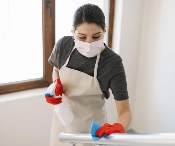 medium-shot-woman-cleaning-railing